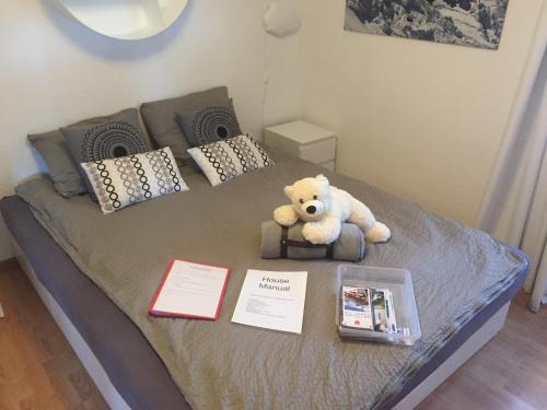 a teddy bear sitting on top of a bed at O 68 Haus Bel Air in Wengen