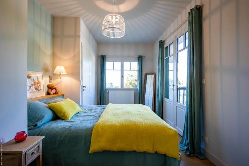 a bedroom with a bed and a large window at CHISTERA in Pyla-sur-Mer