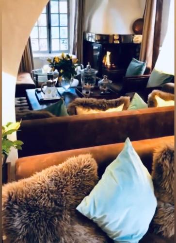 a teddy bear laying on a couch in front of a mirror at Coeur des Neiges in Saint-Gervais-les-Bains