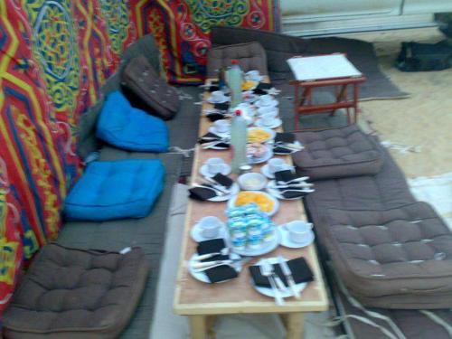 a long table in a play room with couches and a tableablish at Safari Camp Bahariya Oasis in Bawiti
