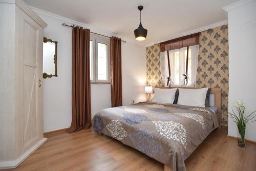 a bedroom with a bed and a window at Palm square apartment 2 in Budva