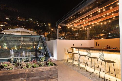 a table and chairs on a balcony at night at Antigua Trece Hotel Fusión in Guanajuato