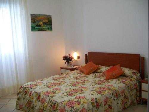 a bedroom with a bed with a floral bedspread at Il Mulino in Furore
