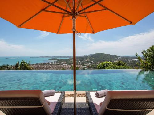 an orange umbrella sitting on top of a swimming pool at Panacea Retreat in Bophut 