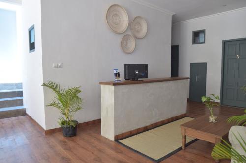 a living room with a counter and a table at Grhatama Guest House in Yogyakarta