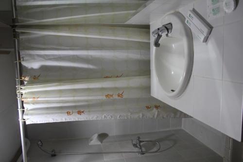 a bathroom with a sink and a toilet at Elegant Circle Inn in Cebu City