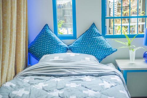 a bedroom with blue walls and a bed with blue pillows at MontView Koh Chang in Ko Chang