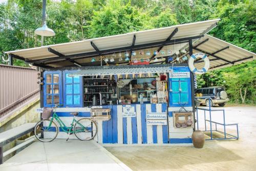a blue food cart with a bike parked in front at MontView Koh Chang in Ko Chang