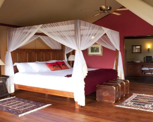 a bedroom with a bed with a canopy at Olare Mara Kempinski in Talek