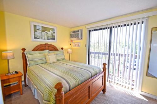a bedroom with a bed and a large window at Harbour Bay 23 Ocean City in Ocean City