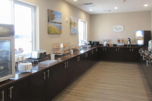 a waiting room with a counter and a tv at Sleep Inn & Suites Oregon - Madison in Oregon