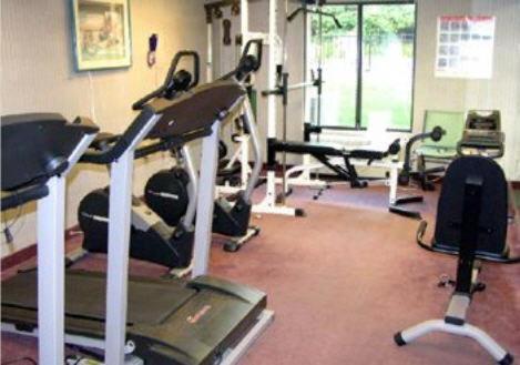 a gym with several tread machines in a room at Aderi Hotel Near Casino in Niantic