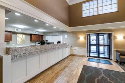 a large lobby with a bar in a room at Quality Inn & Suites Des Moines - Merle Hay Road in Urbandale