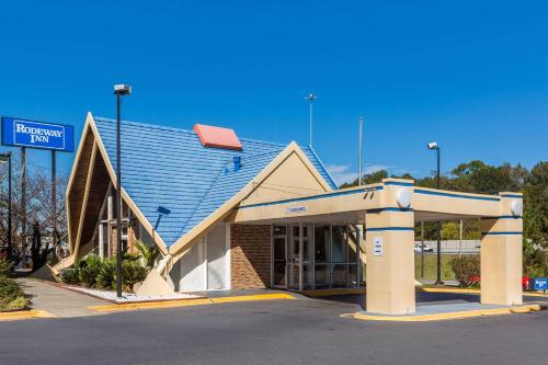 a gas station with a sign in front of it at Super 8 by Wyndham Macon GA in Macon