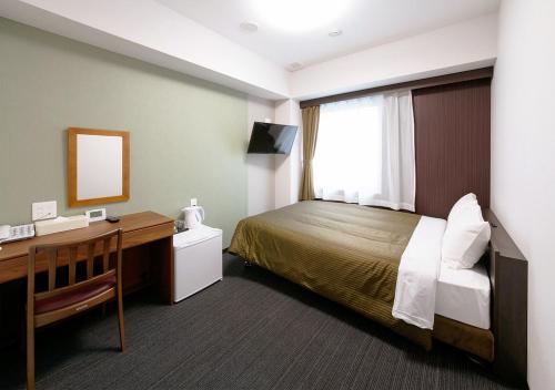 Un pat sau paturi într-o cameră la Hotel Trend Kanazawa Ekimae