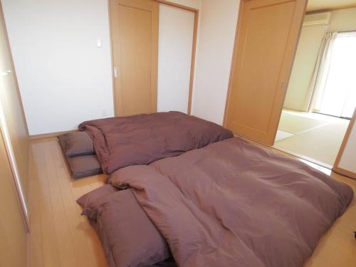 Postel nebo postele na pokoji v ubytování 岡崎Haus
