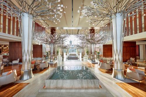 a rendering of the lobby of a hotel with a pool at Mandarin Oriental Jumeira, Dubai in Dubai