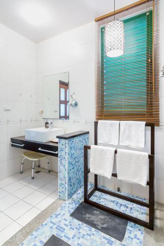 a bathroom with a sink and a mirror at Ville Greensward in Taitung City