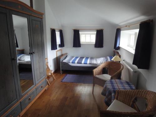 a small living room with a bed and a couch at Haus "Am Kienmoor" in Bad Zwischenahn