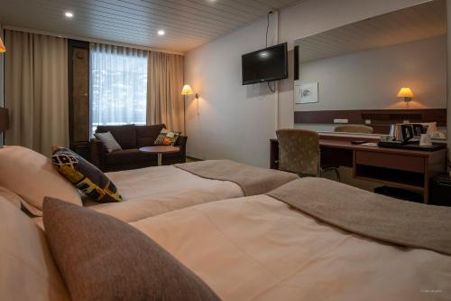 Ένα ή περισσότερα κρεβάτια σε δωμάτιο στο Hotel Mesikämmen