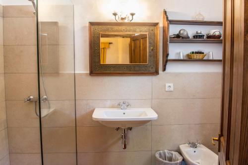 a bathroom with a sink and a shower with a mirror at Hotel Rural Biniarroca - Adults Only in Sant Lluis