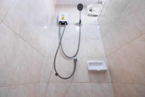 a shower in a bathroom with a blow dryer at Don Muang Hotel in Bangkok