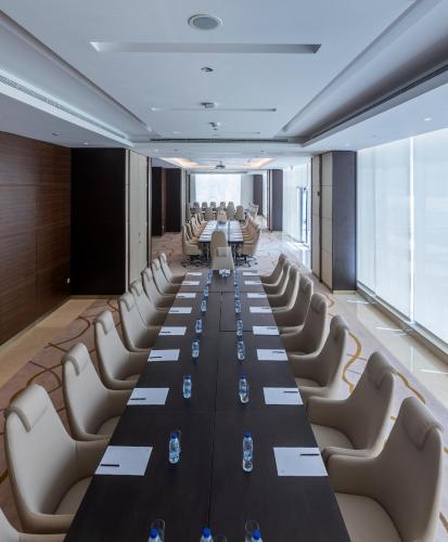 a conference room with a long table and chairs at Ascott Rafal Olaya Riyadh in Riyadh