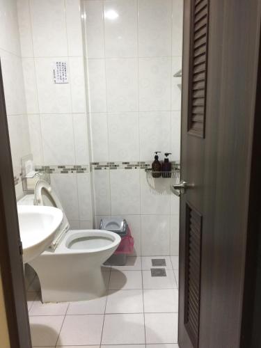 a bathroom with a toilet and a sink at Summerle No.11 in Chaozhou
