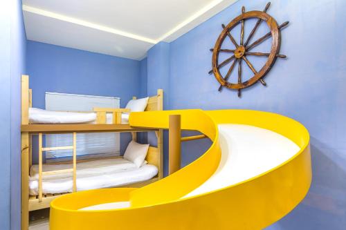 a room with two bunk beds and a wooden wheel at Good time warm home in Tainan