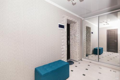 a room with a blue stool and a mirror at проспект Михайла Лушпи in Sumy