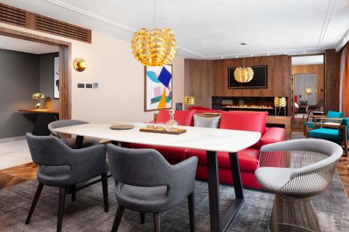 a dining room with a white table and chairs at Sofitel Warsaw Victoria in Warsaw