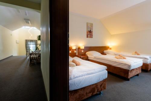 Postel nebo postele na pokoji v ubytování Hotel NORD