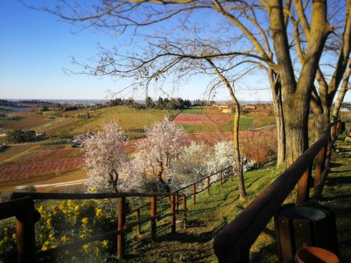 a view from the porch of a house with a fence and trees at Alloggio Al San Girolamo in Longiano