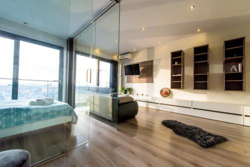 a bedroom with a bed and a glass wall at Kapart Rzeszów Apartment in Rzeszów