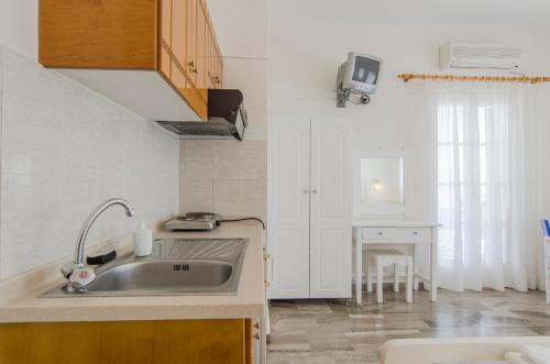 a kitchen with a sink and a table in it at Margarita in Perissa