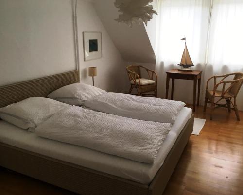 a bed with white sheets on it in a bedroom at Mosel - River - Quartier 31 in Lieser