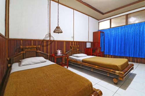 Postel nebo postele na pokoji v ubytování Hotel SAS Syariah