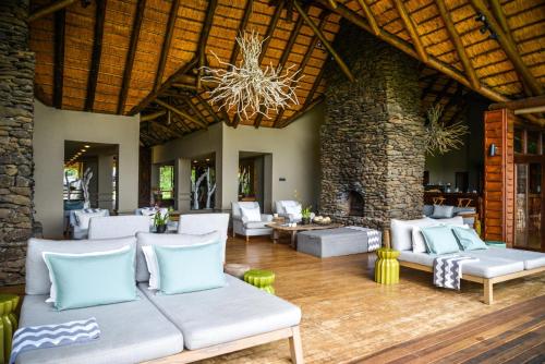 a living room with couches and a fireplace at Lion Sands Narina Lodge in Sabi Sand Game Reserve