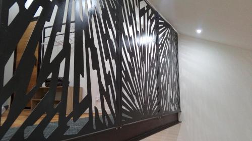 a wall with a black and white painting on it at " Les Lofts de Mérigonde " in Castres