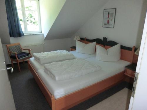 a bedroom with a large bed with white sheets and pillows at Appartement Residenz Bellevue Whg 22 in Zinnowitz