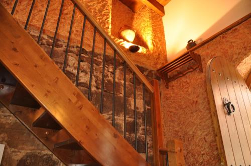 a wooden staircase in a room with a skateboard at CAN LLORENÇ in Prades