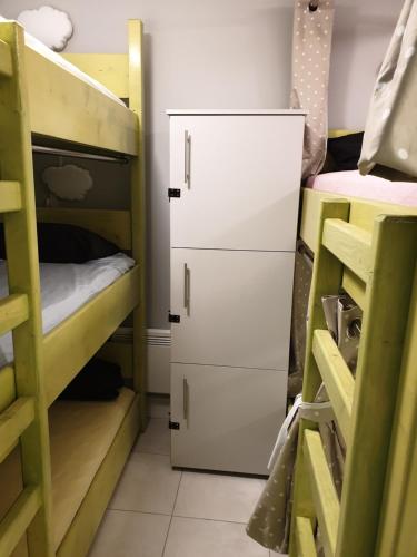 a dorm room with bunk beds and a refrigerator at KGT House in Dublin