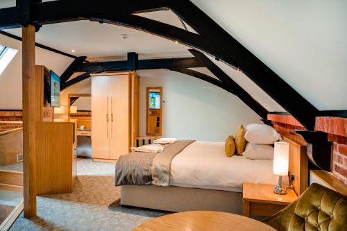 a bedroom with a large bed in a room at Oakley Hall Hotel in Basingstoke