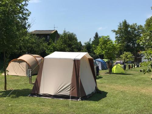 a group of tents in a grass field at Oliver Inn Camping in Balatonlelle