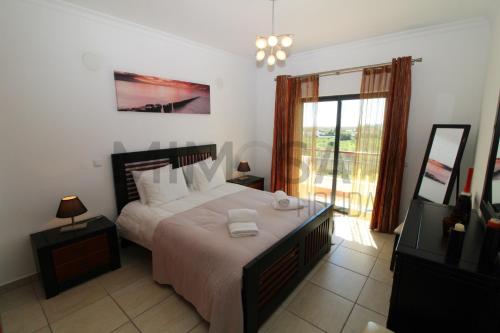 a bedroom with a large bed and a window at Alba Mar in Lagos