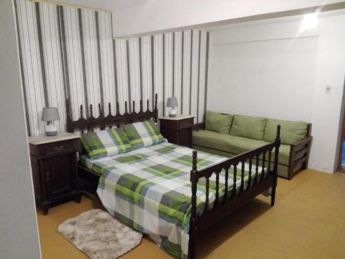 a bedroom with a bed and a couch at Solar de Paz in Rivera