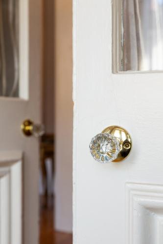 a gold door knob on a white door at Downtown Luxury Victorian Retreat in Toronto