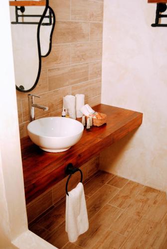 a bathroom with a white sink on a wooden counter at Hotel Boutique TerraNova in Tulum