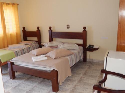 Un pat sau paturi într-o cameră la Palace Hotel