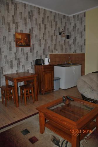 a living room with a couch and a table at Wilinianka in Pieszyce